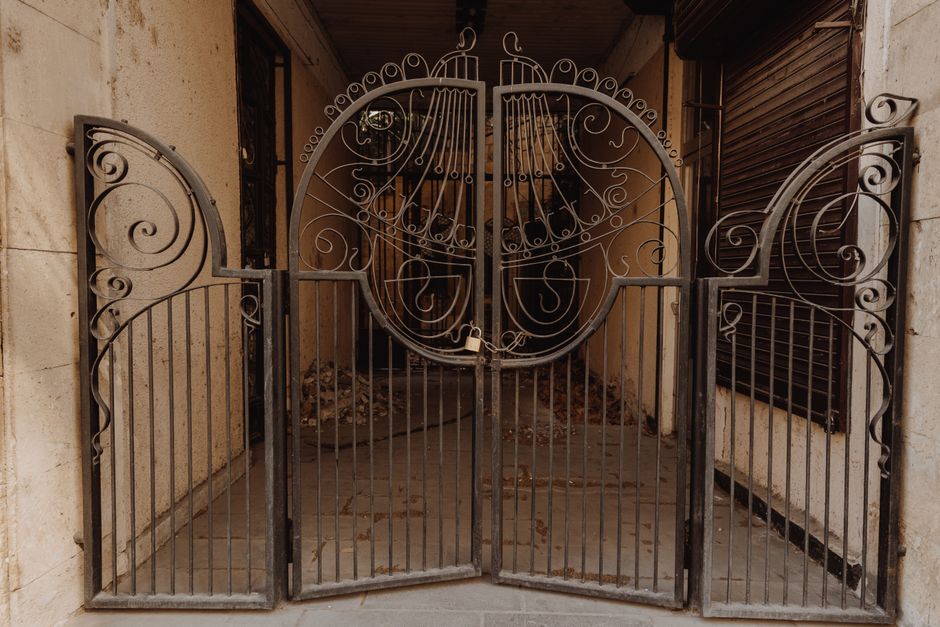 A black metal gate with vertical bars