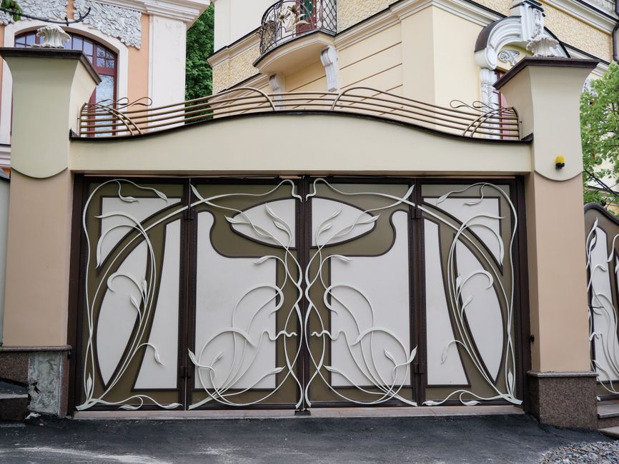 A metal gate framed by stone posts